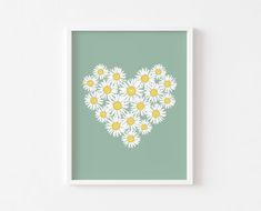 a heart made up of daisies on a green background