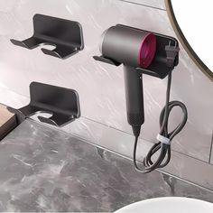 two hair dryers are plugged into the wall