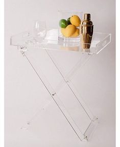 an acrylic shelf with bottles and lemons on it