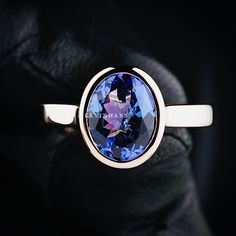 a close up of a ring with a blue stone on it's center piece