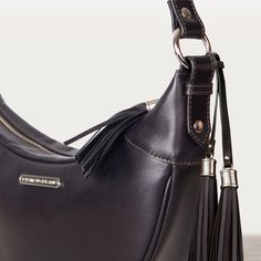 The perfect partner for modern lifestyles, the Elle Half Moon Black Handbag blends equestrian elegance with a sleek, contemporary design. Crafted from luxurious Italian leather with dark tan stitching, this crescent-shaped bag features a wide, adjustable shoulder strap adorned with nickel grommets. The top zipper, complete with a stylish tassel pull, secures a custom interior with zipper pouches and sleeves. Ideal for both stable and city outings, this black leather purse offers EQ Chic and mode Leather Saddle Shoulder Bag With Palladium Hardware, Elegant Brown Saddle Bag With Leather Handles, Saddle Bags With Palladium Hardware For Everyday Use, Elegant Everyday Saddle Bag With Leather Lining, Business Leather Hobo Bag With Palladium Hardware, Elegant Saddle Business Bag, Elegant Saddle Bag For Business, Elegant Business Saddle Bag, Elegant Leather Saddle Bag With Palladium Hardware