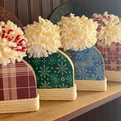 four christmas themed shoes are lined up on a shelf