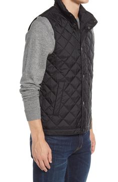 Lightweight and layerable, this quilted nylon vest sports pockets inside and out plus a stand collar and covered placket to help keep the elements at bay. 27 1/2" length (size Medium) Two-way front zip closure with snap storm placket Stand collar Lined, with synthetic fill 100% nylon Dry clean or machine wash, line dry Imported Black Quilted Vest For Cold Weather, Black Quilted Sleeveless Vest, Black Quilted Outdoor Vest, Quilted Black Nylon Vest, Black Quilted Nylon Vest, Quilted Nylon Vest For Cold Weather, Black Quilted Vest For Winter, Sleeveless Quilted Black Outerwear, Black Quilted Outerwear For Outdoor Activities