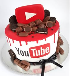 a cake decorated with chocolate chips, cookies and a youtube sign on top that says you tube