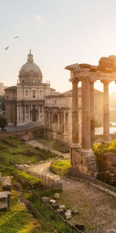 an ancient city with ruins and columns in the foreground