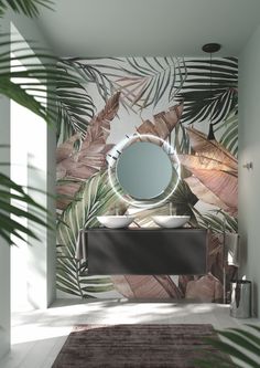 a bathroom with palm leaves on the wall and a round mirror in the middle, along with a rug