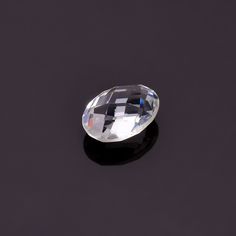 an oval shaped diamond on a black surface