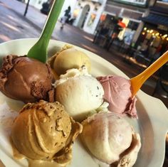 a white plate topped with different types of icecream on top of a table