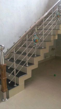 a metal stair rail with glass balls on the handrails in an empty room