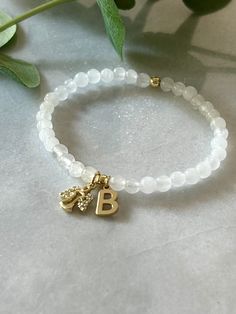 - Beautiful custom guardian angel bracelet with initial is the sweetest bracelet to have in your collection. Wear it for protection or as reminder of a loved one. Personalized angel bracelet is strung on high quality stretch cord and secured. - 4.5mm white jade beads    4mm 18k gold filled accent beads   gold angel charm with cubic zirconia - Each purchase is sent in a drawstring velvet jewelry bag, making a special loss bracelet gift, sympathy gift, anyone special or just for yourself.  - To ca Parent Loss, Angel Bracelet, Bracelet Initial, Angel Charm, Memorial Bracelet, Child Loss, Gold Angel, Velvet Jewelry, Jewelry Bag