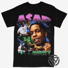 ASAP Rocky Tee Shirt Hip Hop Rap Style Concert Tour Music Artist Merch Casual Black Top For Music Festivals, Casual Black Tops For Music Festivals, Hip Hop Graffiti Print Top For Concert, Hip Hop Tops With Graffiti Print For Concert, Hip Hop Graphic Print Tops For Concerts, Hip Hop Tops With Graphic Print For Concerts, Graphic Print Tops For Music Festivals Streetwear, Hip Hop Shirt With Graphic Design For Concerts, Black Music-themed Short Sleeve Shirt