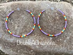 "Here's a pair of purple with native colors beaded hoop earrings that are lightweight and comfortable to wear all day long. Made with high quality glass Delica Beads, beaded one bead at a time. Love and passion goes into making my jewelry. This process requires focus, patience and dedication. Each bead is 16th of an inch and can take hours to complete a project. They are 2\" around.  They would be a great addition to your wardrobe. This would make a great gift for someone special or a treat for yourself. Handmade is from the Heart ❤️ Handmade in Arizona 🇺🇸 Thank you for stoping by.  Have a great day." Purple Heishi Bead Jewelry With Colorful Beads, Purple Beaded Earrings With Round Beads For Festival, Purple Beaded Hoop Earrings With Round Beads, Adjustable Small Purple Hoop Earrings, Festival Purple Beaded Earrings With Round Beads, Adjustable Nickel-free Purple Hoop Earrings, Purple Beaded Dangle Hoop Earrings, Purple Beaded Round Hoop Earrings, Purple Colorful Beaded Earrings For Festival