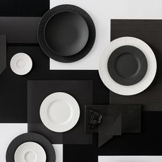 black and white table setting with plates, napkins and utensils on it