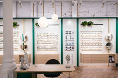 the interior of a optician's office with several rows of eyeglasses