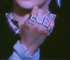 a close up of a person holding some type of object in their hand with the word glam on it