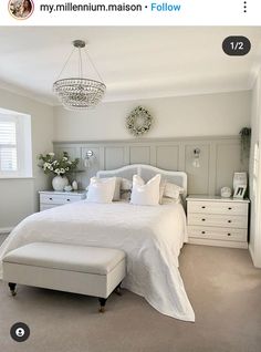 a white bed sitting in a bedroom next to a window