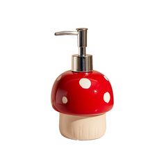 a red mushroom shaped soap dispenser on a white background