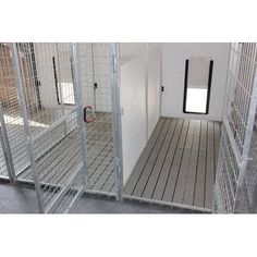 the inside of a jail cell with doors open