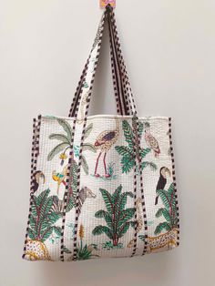 "Cotton quilted Jhola Bag made by Indian Artisans, this cotton quilted shopping bag is totally unique and multi purpose. Use this for your grocery or as a travel bag. Perfect to suit all. The Indian Hand Block Printed Cotton Quilted Women's Handbags from Rajasthan India. This Handbag is completely Indian Printed on good quality cotton. Material-  Cotton Fabric Color- White Pattern- Jungle Print Style: Tote Bag, Handle Bag, Shoulder Bag Size in Inch:- Height-18\" inch Width- 19\" inch Handle-13\" inch Product Work: Printed & quilted Stitched Usage : Cosmetic, Make-up, Travel, Toiletries, Medicine, Accessories, Shopping and much more. Perfect for Beach Visits/ Quick Grocery runs/ Carrying Kids items/ Artist Paint book and Paints /Extra Bag Washable on Cold / Delicate wash Make a good Sustain Indian Quilt, Cotton Handbag, Bridesmaid Bags, Hippie Bags, Quilted Tote Bags, Quilted Handbags, Jungle Print, Tote Bags Handmade, Quilted Totes