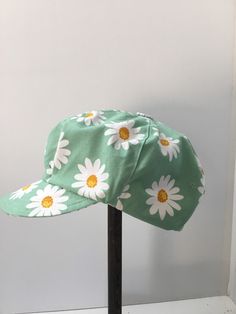 "Womens newsboy, slouchy cap has been sewn from a fresh green white daisy print. The cap is fully lined , with a topstitched brim or peak. The six panels have been finished with a hand made button. This is a bright summer casual cap.. pop it on to go shopping, wear on the weekend with jeans or take on holiday.... Foldable and washable.... (the fabric has been  prewashed) There is an elastic cord for adjusting. Please check your head measurements with those below. A comfy and soft cap which sits Cotton Flat Cap For Summer, Retro Visor Baseball Cap For Spring, Green Curved Brim Baseball Cap For Summer, Vintage White Baseball Cap For Summer, Retro Green Cotton Hat, Green Retro Cotton Hat, Green Snapback Baseball Cap For Summer, Green Cotton Baseball Cap For Spring, Vintage Cotton Baseball Cap For Summer