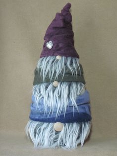 there is a stuffed gnome made out of jeans and hats