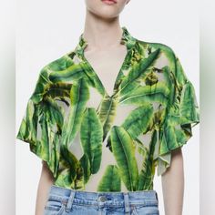 A Ruffle-Trim Stand Collar Tops This Silk-Rich Blouse Covered In A Tropical Palm Print And Framed By Fluttery Elbow-Length Sleeves. Stand Collar Split Neck Elbow-Length Sleeves 67% Viscose, 33% Silk Silk V-neck Top For Vacation, Tropical Green Printed Blouse, Silk Blouse For Vacation, Elegant Printed Tops For Vacation, Chic Silk Beach Blouse, Silk Short Sleeve Beach Tops, Chic Green Blouse For Vacation, Silk Printed Blouse For Vacation, Summer Silk V-neck Blouse