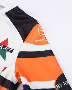 an orange, black and white rugby jersey with the name art on it's chest