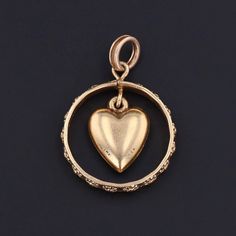 A golden heart dangling inside a wedding band -- a symbol of unending love. This vintage heart pendant is engraved date 8-28-48 and dangles inside a wedding band. The piece is 14k gold and measures 1.1 inches from top of the jump ring to bottom by 0.8 inches wide. Materials: Gold. Vintage Charm Pendant Jewelry For Anniversary Gift, Vintage Jewelry With Heart Charm For Anniversaries, Vintage Charm Heart Pendant Jewelry For Anniversary, 14k Gold Round Pendant Charms For Anniversary, 14k Gold Heart Charm Wedding Jewelry, Yellow Gold Promise Jewelry With Heart Charm, Anniversary Gift Pendant Jewelry With Vintage Charm, Heirloom Jewelry With Charms For Anniversary, Vintage Rose Gold Promise Jewelry