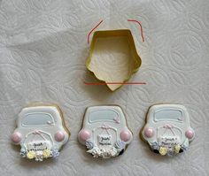 three decorated cookies in the shape of cars