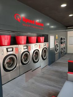 the washer and dryer machines are lined up against the wall in this laundry room