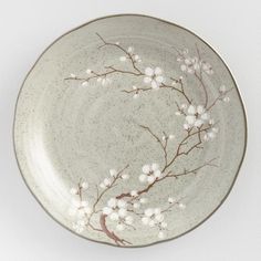 a plate with white flowers and branches painted on it