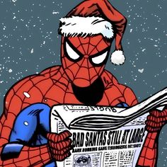 a spider - man wearing a santa hat and holding a newspaper in front of him