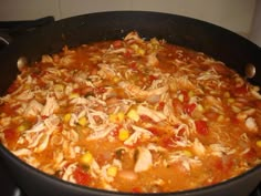 a pot filled with chicken and corn soup