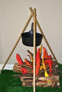 a fire pit made out of sticks and grass