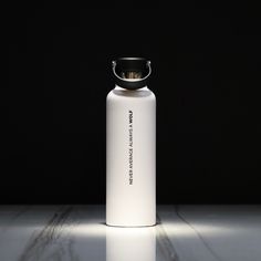 a white bottle sitting on top of a table