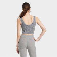 Upgrade your sleepwear with this Ribbed Seamless Reversible Tank Top from Colsie™. This cropped slim fit tank top features a reversible design with a ribbed-textured finish, a deep U-neck and a V-back for breezy flair. The soft and stretchy seamless fabric offers flexible movement and a more comfortable fit, while the pullover style allows for easy wear. Colsie™: All You, Inside and Out. Stretch Scoop Neck Activewear For Loungewear, Casual Seamless Crop Top For Loungewear, Seamless Tops For Loungewear, Seamless Snug Fit Activewear For Loungewear, Stretch Scoop Neck Sports Bra For Loungewear, Sleeveless Seamless Tops For Loungewear, Fitted Seamless Sports Bra For Loungewear, Gray Stretch Crop Top For Loungewear, Gray Stretch Tank Top For Loungewear