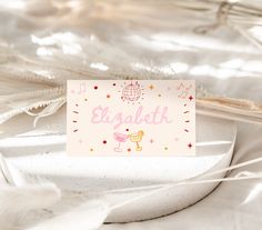 a card that says english on it sitting on a table with feathers and other items