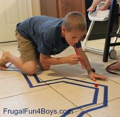 a boy on the floor playing with tape