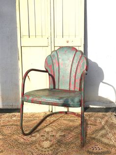 an old chair sitting on top of a rug in front of a white door and doorway