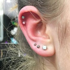 a close up of a person's ear with piercings