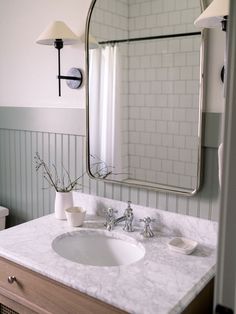 a bathroom sink with a mirror above it