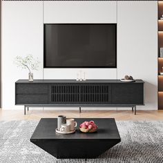 a living room with a large television on the wall and coffee table in front of it