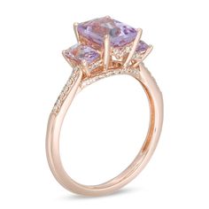 A classic look in romantic color, this gemstone and diamond ring is a stunning accessory she'll wear with everything. Crafted in 14K rose gold, this bold three-stone design showcases a trio of emerald-cut pink quartz - the largest the 8.0 x 6.0mm center stone - each wrapped in a diamond-touched setting. Diamonds line the shank and gallery for an added hint of shimmer. Radiant with 1/6 ct. t.w. of diamonds and a brilliant buffed luster, this choice offers eye-catching style. This ring is availabl Elegant Rose Gold Diamond Ring With Accent Stones, Luxury Rose Gold Rings With Accent Stones, Elegant Rose Gold Three Stone Ring, 14k Rose Gold Rings With Diamond Accents, Fine Jewelry 14k Rose Gold Rings With Diamond Accents, Fine Jewelry Amethyst Ring In Rose Gold, Rose Gold Amethyst Ring Fine Jewelry, Elegant Pink Three Stone Rings, Formal Rose Gold Three Stone Jewelry