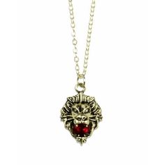 a necklace with a red stone in the center and an animal's head on it