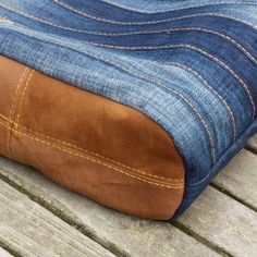 a blue and brown bag sitting on top of a wooden table