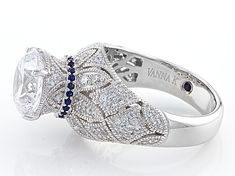 Vanna K ™ for Bella Luce ® white diamond simulant and lab created blue sapphire, 7.78ctw, round,  Platineve® ring. Measures approximately 1/2"L x 1/8"W and is not sizeable. Each Vanna K™ design has a signature label that features a lab created sapphire. White Sapphire Ring With Diamond Accents, Luxury White Sapphire Ring With Cubic Zirconia, White Sapphire Ring With Diamond Accents In Cubic Zirconia, Elegant White Sapphire Diamond Ring, White Cubic Zirconia Sapphire Ring With Prong Setting, Luxury White Sapphire Ring With Accent Stones, White Sapphire Ring With Prong Setting, Formal White Sapphire Ring With Accent Stones, White Cubic Zirconia Sapphire Ring With Diamond Cut