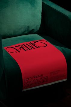 a green chair with a red blanket on it's back and the word dalids written in black