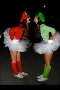 two women dressed in costumes standing next to each other