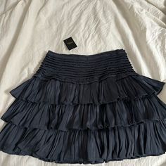 Reset Ruffle Skort Chic Pleated Tiered Bottoms, Chic Tiered Pleated Bottoms, Blue Tiered Bottoms With Ruffle Hem, Chic Blue Tiered Bottoms, Chic Blue Tiered Skirt, Casual Blue Tiered Bottoms, Chic Blue Ruffled Skort, Blue Tiered Bottoms With Elastic Waistband, Ruffle Skort