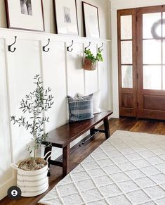 a wooden bench sitting next to a white rug